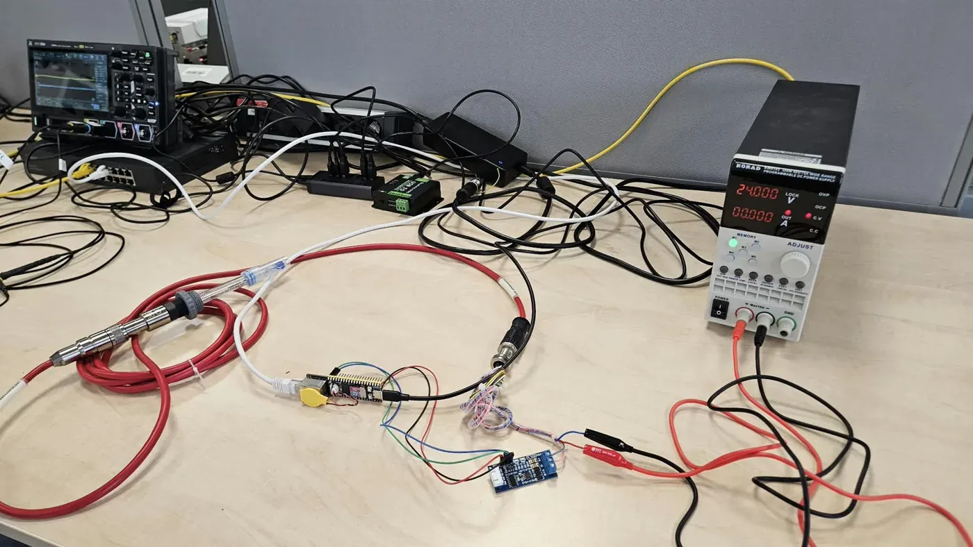A microcontroller board on a lab bench, powered from a bench supply and probed with an oscilloscope during firmware bring-up.