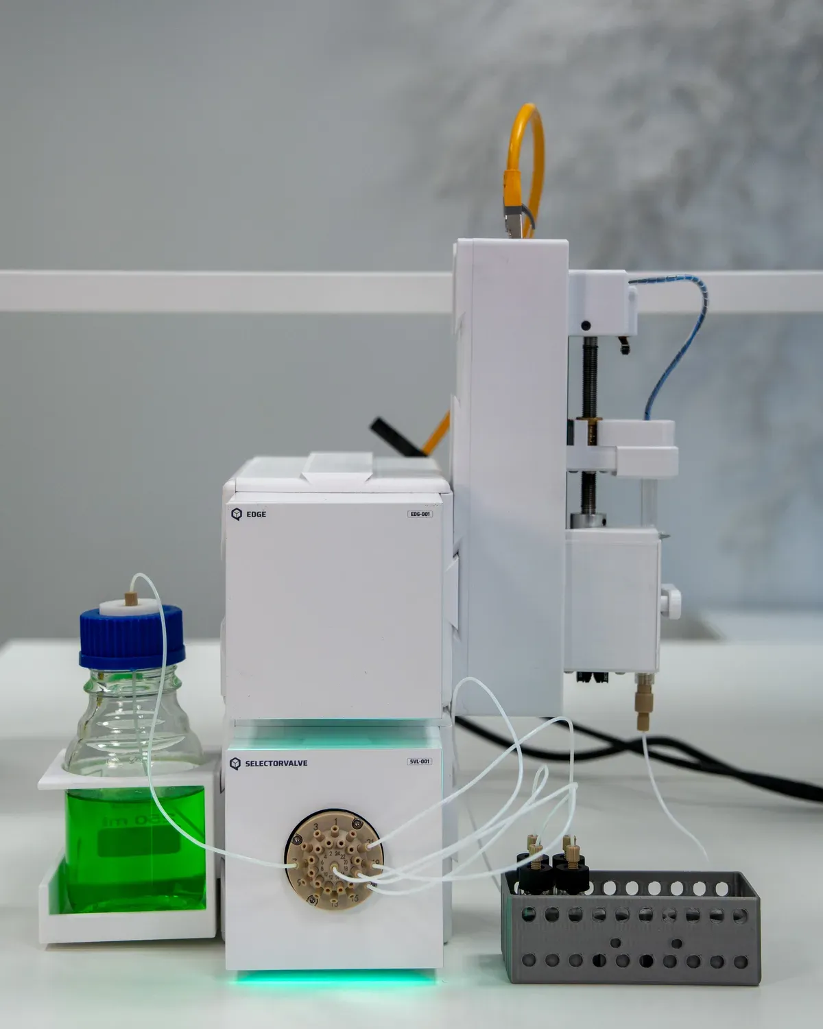 QB AutoSampler setup on a lab bench: QB Edge, QB Selector Valve and QB Syringe Pump with a media bottle and a vial rack