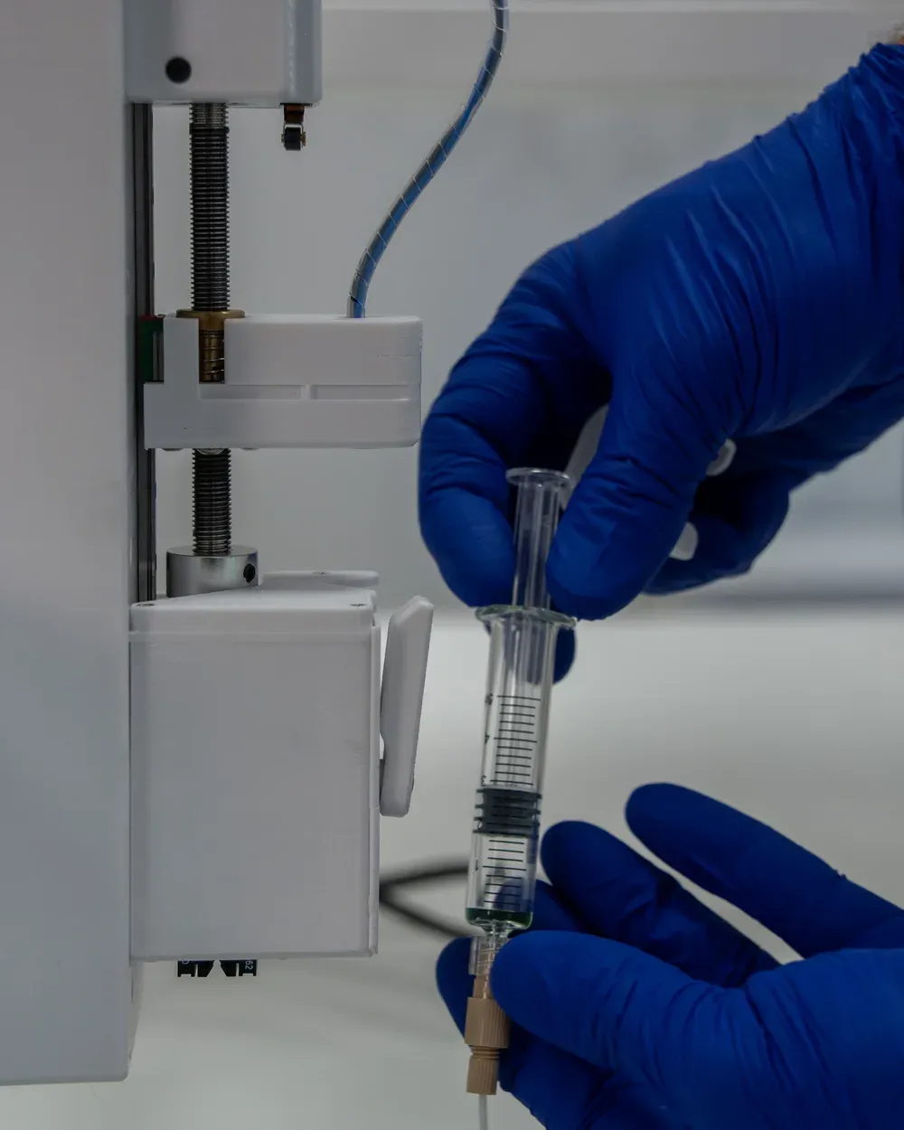 A single-use syringe being fitted to the QB Syringe Pump